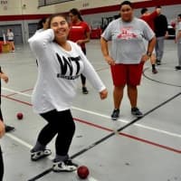 <p>Sacred Heart University women&#x27;s track &amp; field team co-captain Lindsay Aponte, left, works with Blackham School students during a recent throwing clinic in the Pitt Center. Fellow team member Kolbi Smith, right, looks on. </p>