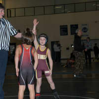 <p>Jacob Gonzales has his hand raised after a victory.</p>