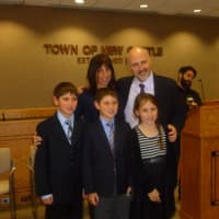 <p>Supervisor Robert Greenstein poses with his family at New Castle Town Hall before his inauguration. </p>