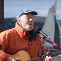 <p>Pete Seeger sings with the Clearwater sailing behind him. </p>