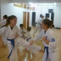 <p>Two young martial artists spar at Kenshikai Karate.</p>