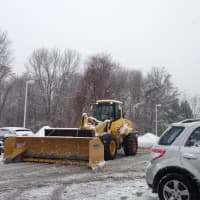 <p>A construction vehicle is used to plow the Somerstown Shopping Center Monday. </p>