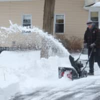 <p>Bob McCann clears his driveway Wednesday morning. </p>