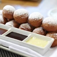 <p>Moderne Barn&#x27;s Petits Beignets: fried doughnut holes, strawberry preserves, caramel sauce &amp; dark chocolate sauce</p>
