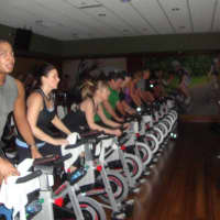 <p>Members participate in a demonstration of the spin classes offered at Life Time Fitness.</p>