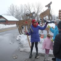 <p>Anne Marie Marx (left) holds up signs protesting deer culling. </p>