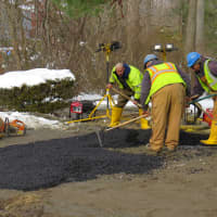 <p>Crews work Sunday in New Rochelle to repair the road.</p>