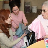 <p>A Waveny LifeCare Network receives a scarf from Caren &amp; Forbes.</p>