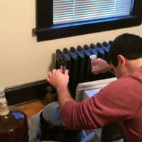 <p>Dan Latham extracts a sample of one of the still fermenting beers to test the alcohol levels and taste. </p>