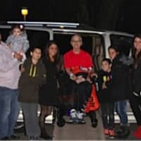<p>Vince Yackery sits in a van surrounded by his family. The van was purchased with support from the Darien community.</p>