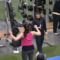 <p>A woman gets a work out with a Club Fit trainer.</p>