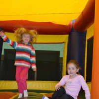 <p>Children are all laughs and smiles as they play in bouncing houses at the Club Fit open house.</p>
