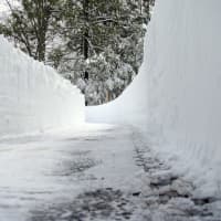 <p>Snow is piled up on a driveway on Ferndale Drive in Easton from a storm in 2011. </p>