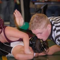 <p>A referee gets ready to signal a pin and a win or Norwalk&#x27;s Dougie Cahill in New London.</p>