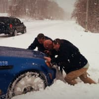 <p>Yonkers Mayor Mike Spano gives officers a helping hand when a county police car got stuck in the snow.</p>