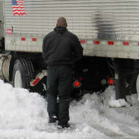 <p>A truck driver faced an uphill battle attempting to dig his rig out of the snow in Scarsdale.</p>
