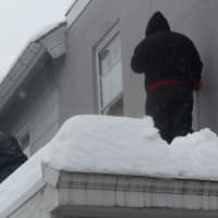<p>Westchester rooftops are packed with up to a foot or more of snow with property owners having to remove the weight.</p>