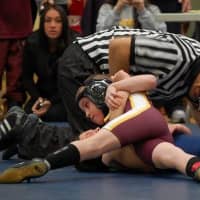 <p>Jacob Gonzales works on pinning his opponent.</p>