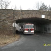 <p>A photo taken by a consultant for Conifer Realty shows a Chappaqua fire truck driving under a bridge near 54 Hunts Place. </p>