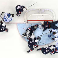 <p>Finland&#x27;s Kimmo Timonen, #44, loses his helmet against Zach Parise, #9, Jonathan Quick, #32, and Ryan McDonagh, #27, of the United States in the first period of Saturday&#x27;s game. </p>