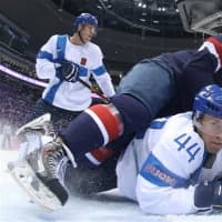<p>Ryan McDonagh, #27, of the United States falls on Kimmo Timonen, #44, of Finland in the first period of the Bronze Medal game Saturday at the Sochi Olympics.</p>
