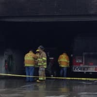 <p>Crews survey the damage at the Goldens Bridge fire house after a blaze destroyed the building on Monday morning.</p>