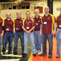 <p>Norwalk Mad Bull coaches line up prior to the competition.</p>