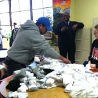 <p>Stamford&#x27;s Mason Perkins and Zionna Matulis are at the soup kitchen with Brian Jenkins. </p>