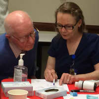 <p>Respiratory therapist Marie Muller discusses the results of this visitors pulmonary test with him</p>