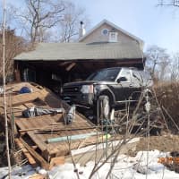 <p>The garage of a home on Cunningham Place in Westport was heavily damaged Thursday morning after a Land Rover SUV drove through it. </p>