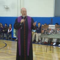 <p>Cardinal Timothy Dolan praises George and Marie Doty and the new gym built in their memory at the Resurrection School in Rye.</p>