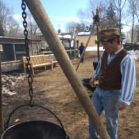 <p>Kevin Meehan watches over the frozen sap get boiled down over an open fire the way the settlers did. </p>