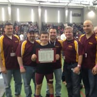 <p>Norwalk Mad Bulls wrestler Jeff Cocchia, a state champion, gets congratulations from coaches (left to right) Randy Haus, David Slapin, Marco Hernandez, Art Schad, Jason Singer and Sam Ward.</p>