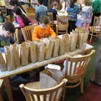 <p>Students worked in an assembly line to create the bagged lunches. </p>