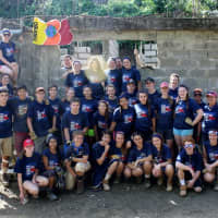 <p>Students from the &quot;Rhombo&quot; Team pose in front of a health clinic they helped to erect. Students on this team represent schools in Fairfield and Westport.</p>