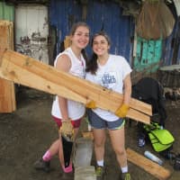 <p>Emily Castro (Weston High School senior) and Blake Rubin (Staples High School sophomore) gather materials to build a latrine in the Paso de Moca community in the Dominican Republic.</p>