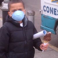 <p>A child wears a mask in East Harlem near the site of a deadly building explosion caused by a gas leak.</p>