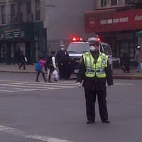<p>A police officer wears a mask in East Harlem as they man the scene after a deadly building explosion caused by a gas leak.</p>