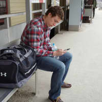 <p>Freddie Mason checks for Metro-North updates on his phone Wednesday in Westport. </p>