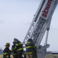 <p>Ossining firefighters at First Baptist Church in Ossining, securing a wobbly church steeple. </p>