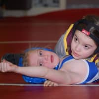 <p>Cali Gilchrist of the Norwalk Mad Bulls wrestles in Sunday&#x27;s state championships.</p>