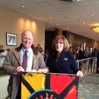 <p>A painting by keynote speaker Erik Wahl was raffled off and won by Bruce Baker, holding the painting, with Gail Malloy.</p>