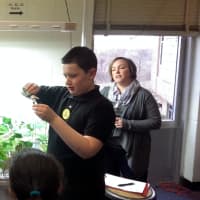<p>Jefferson Magnet School fifth-grader Mason checks the pH levels on the hydroponic garden with Norwalk Grows director Lisa Lenskold looking on. </p>