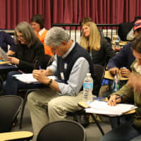 <p>Judges make notes during the exhibit.</p>
