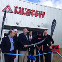 <p>Mount Kisco Mayor Michael Cindrich and state Assemblyman David Buchwald help cut the ribbon on Westchester MMA Fitness&#x27; re-launch Monday. </p>