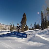 <p>Julia Marino rides a rail on her snowboard.</p>