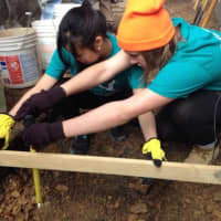 <p>Dobbs Ferry&#x27;s Midori Kihara. left, helps rebuild a home for a Pennsylvania during her spring break from Providence College.</p>