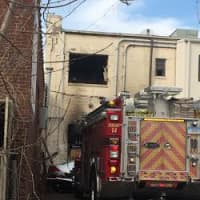 <p>A fire truck is parked behind Engravers World, where the blaze began Thursday morning. </p>
