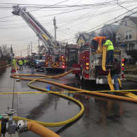 <p>Firefighters battle a three-alarm house fire on 94 State Street in Ossining early Friday afternoon.</p>
