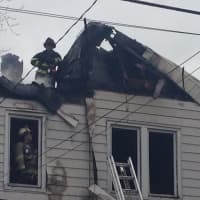 <p>Shortly after firefighters arrive at the scene of a three-alarm house fire on 94 State Street in Ossining on Friday, there was a partial roof collapse.</p>